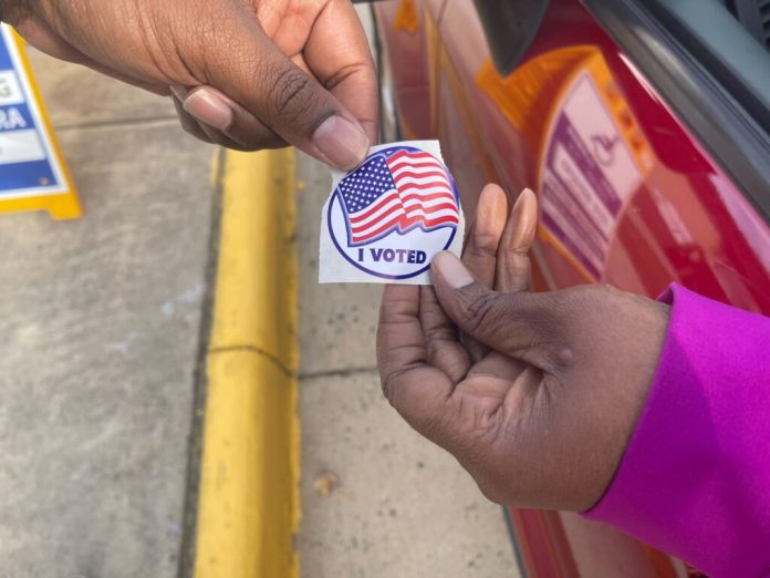 A Fairfax County voter receives a sticker on Election Day, Nov. 4, 2025. (Photo by Nathaniel Cline/Virginia Mercury)