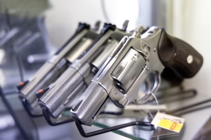 Handguns are displayed in New Jersey. Virginia Attorney General Jay Jones joined a coalition of states opposing a proposed U.S. Postal Service rule that would allow certain firearms to be shipped through the mail, warning it could bypass background checks and weaken enforcement of state gun laws. (Photo by Aristide Economopoulos /NJ Monitor)