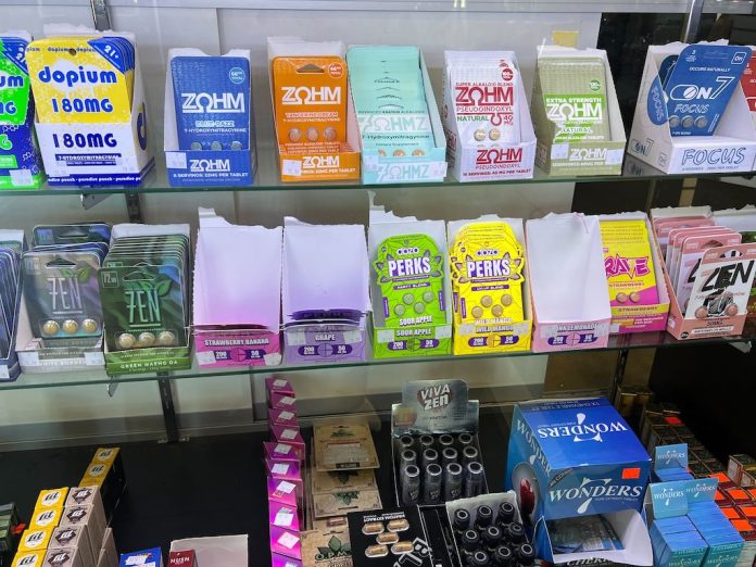 A variety of kratom and 7-OH products — including capsules, cartridges and wellness shots — are on display at a smoke shop in Buffalo, N.Y. States have led the way in regulating kratom, and last year, federal officials moved to ban 7-OH, a powerful compound found in some kratom products. (Photo by Amanda Hernández/Stateline)