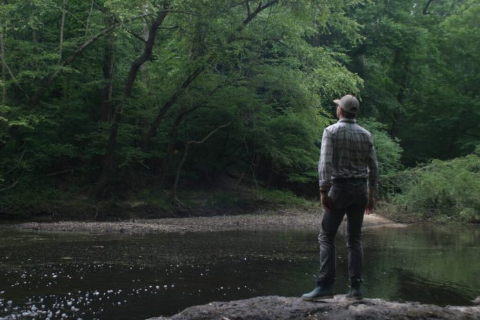 Tom Dunlap, a Riverkeeper with the James River Association, looks over Swift Creek where toxic leachate from the Shoosmith Landfill is leaking in June 2026. (Photo by Shannon Heckt/Virginia Mercury)