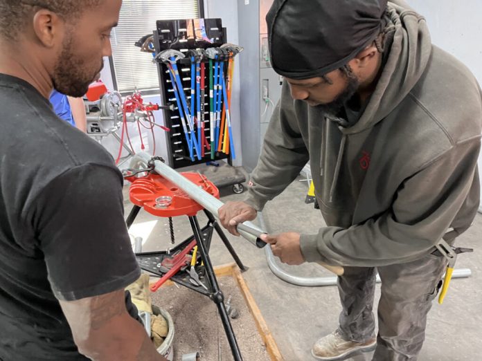Students enrolled at IBEW Local 666's Apprenticeship Program learn how to bend and install electric conduit. (Courtesy of IBEW Local 666)