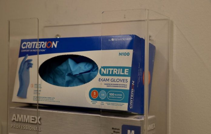 Exam gloves in a health clinic. (Photo by Charlotte Rene Woods/Virginia Mercury)