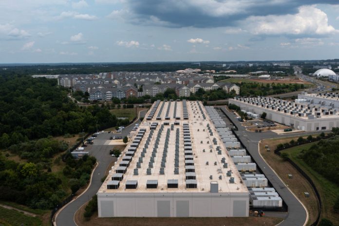 An aerial view shows an Amazon data center in Ashburn, Virginia. PJM Interconnection got the OK from the U.S. Department of Energy to require data centers to turn on back-up generators during this week’s heatwave. (Photo by Nathan Howard/Getty Images)